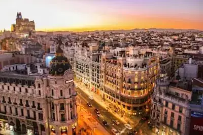 Madrid's Gran Via lit up at sunset