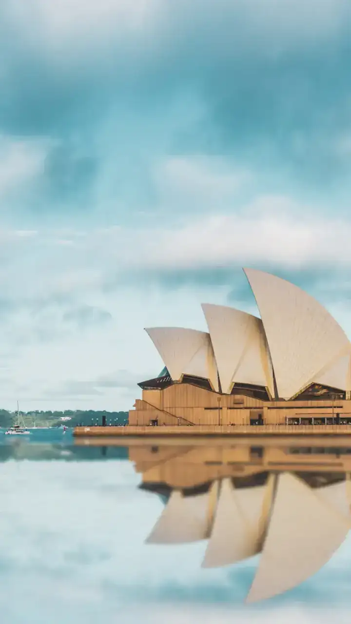 The Sydney Opera House mirrored in the still water of the harbour