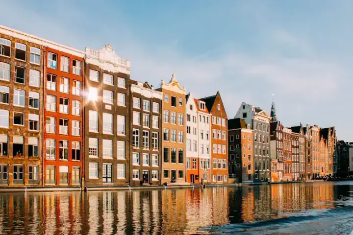 Amsterdam's narrow canal houses reflected in the water