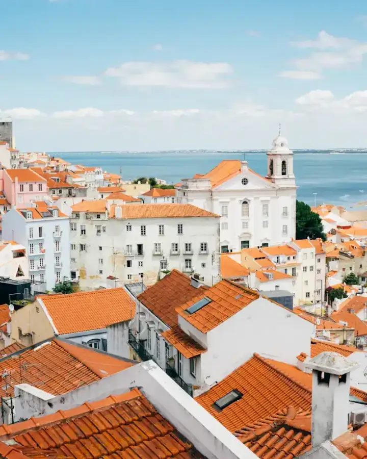 Terracotta rooftops of Lisbon's Alfama district above the Tagus
